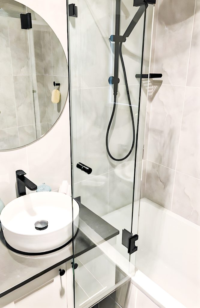 Copy of frameless over bath shower with matt black fittings